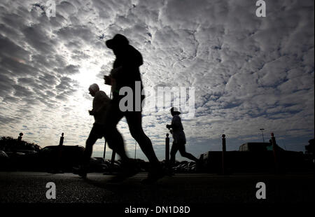 Feb 11, 2006; San Antonio, TX, USA; Altocumulus clouds hover over a trio of runners as they head for the last stretch of a five-kilometer run at UTSA's 22nd annual Diploma Dash on Saturday, Feb. 11, 2006. Over 800 runners and walkers braved stiff winds and cold temperatures from a northern cold front that moved into the area as they took part in a run that benefitted student progra Stock Photo