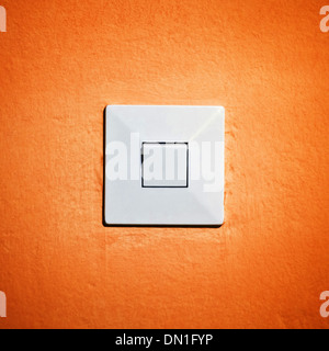 Vintage light switch on orange wall. on and off concept Stock Photo
