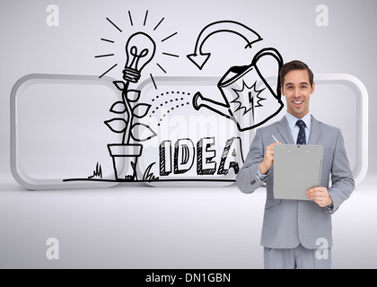 Composite image of happy businessman holding a clipboard Stock Photo