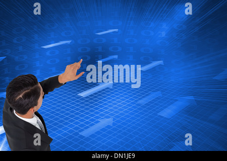 Composite image of asian businessman pointing Stock Photo