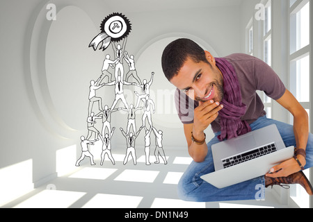 Composite image of thoughtful man sitting on floor using laptop and smiling at camera Stock Photo
