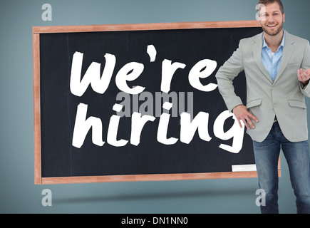 Composite image of stylish man smiling and gesturing Stock Photo
