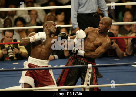 Apr 08, 2006; Las Vegas, NV, USA; FLOYD MAYWEATHER JR. vs ZAB JUDAH IBF Welterweight Fight. When JUDAH Punched MAYWEATHER below the belt  ROGER MAYWEATHER trainer & Uncle jumped into the ring & went after ZAB JUDHA (R) red & black trunks. Nevada athletic Chief Inspector TONY LATO background Blue shirt & inspectors in burgandy along with the Metro police quickly jumped into the ring Stock Photo