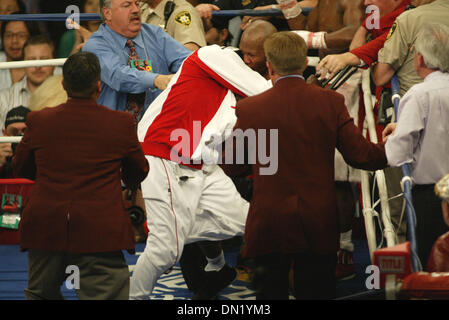 Apr 08, 2006; Las Vegas, NV, USA; FLOYD MAYWEATHER JR. vs ZAB JUDAH IBF Welterweight Fight. When JUDAH Punched MAYWEATHER below the belt  ROGER MAYWEATHER (white & red jogging suit)trainer & Uncle jumped into the ring & went after ZAB JUDHA (R) red & black trunks. Nevada athletic Chief Inspector TONY LATO background Blue shirt & inspectors in burgandy jackets along with the Metro p Stock Photo