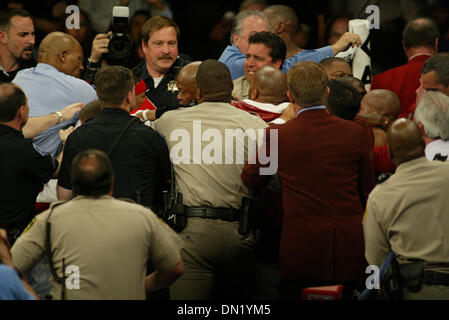 Apr 08, 2006; Las Vegas, NV, USA; FLOYD MAYWEATHER JR. vs ZAB JUDAH IBF Welterweight Fight. When JUDAH Punched MAYWEATHER below the belt  ROGER MAYWEATHER trainer & Uncle jumped into the ring & went after ZAB JUDAH.  ZAB's father/ trainer JOEL JUDAH center in middle of scuffle. Nevada athletic Chief Inspector TONY LATO background Blue shirt & inspectors in burgandy jackets along wi Stock Photo