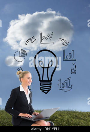 Composite image of businesswoman using laptop Stock Photo