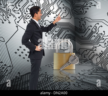 Composite image of smiling asian businessman pointing Stock Photo