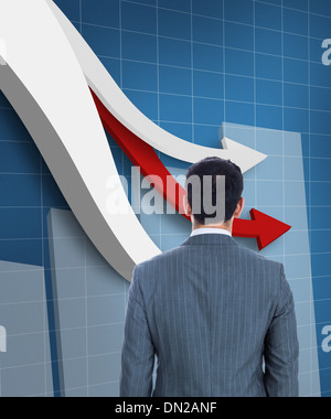 Standing businessman with red graph arrow Stock Photo - Alamy