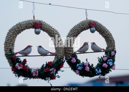 Flower bouquets with hand made Sun birds seated in balance. Stock Photo