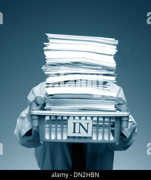 Man Carrying an overflowing inbox Stock Photo