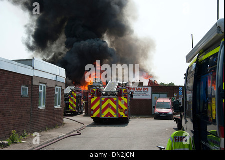 Fire Engines at large factory fire smoke flames big Stock Photo