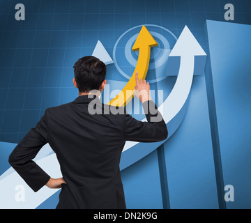 Composite image of asian businessman pointing Stock Photo