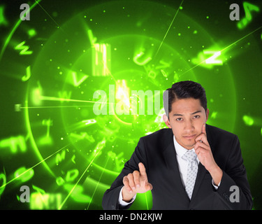 Composite image of thoughtful asian businessman pointing Stock Photo