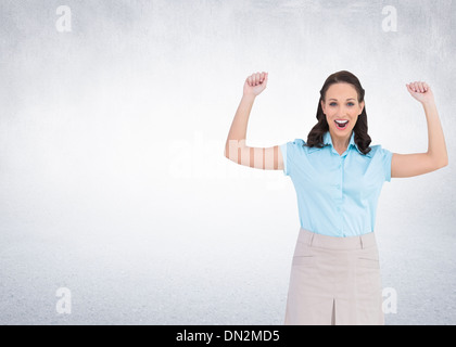 Composite image of victorious stylish businesswoman posing Stock Photo