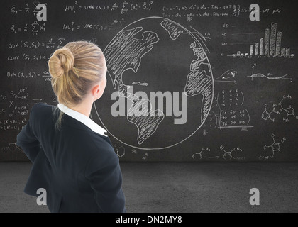 Composite image of businesswoman standing with hands on hips Stock Photo