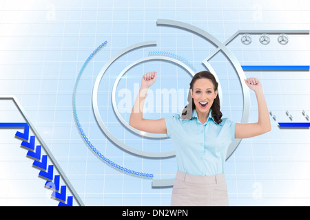 Composite image of victorious stylish businesswoman posing Stock Photo