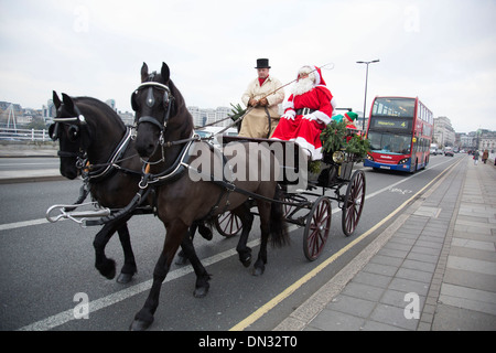 Santa Clause in a horse drawn carriage driving through central London, UK. Surprising members of the public and bringing some Christmas festive atmosphere. Stock Photo