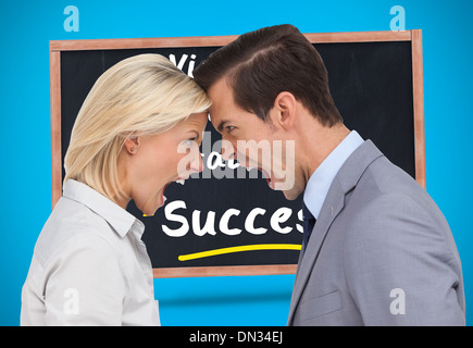 Composite image of colleagues quarreling head against head Stock Photo
