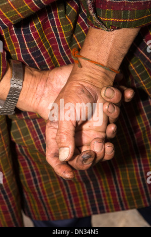 Bhutan, Thangbi Mani Lhakang Tsechu Festival, dirty hands of male festival goer Stock Photo