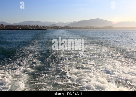 waves formed by the engine of a ship at sea Stock Photo