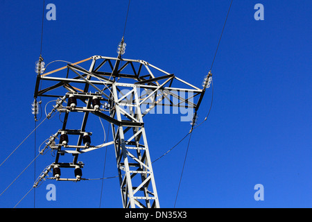 High voltage tower with blue sky behind Stock Photo