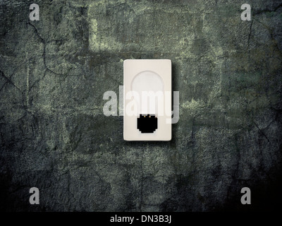 old light switch on a grunge wall Stock Photo