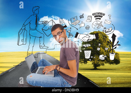 Composite image of man wearing glasses sitting on floor using laptop and looking at camera Stock Photo