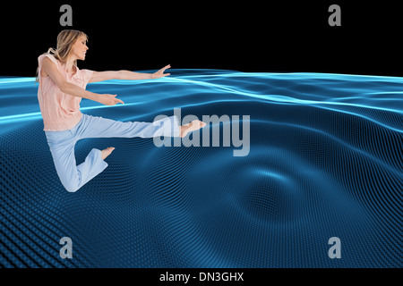 Composite image of woman doing dance pose Stock Photo