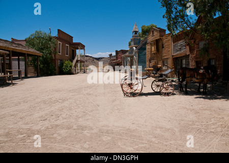 Empty Dirt Street In An Old Western Town With Various Wooden