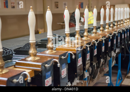 Row of many CAMRA beer pumps at a real ale, beer and cider festival Stock Photo