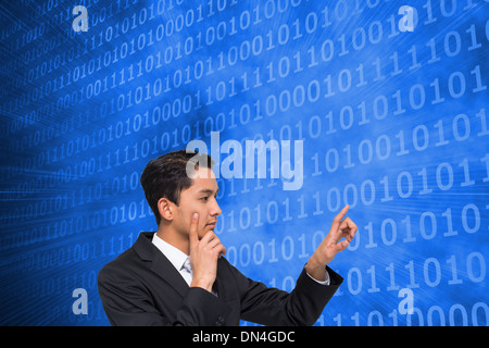 Composite image of thoughtful asian businessman pointing Stock Photo