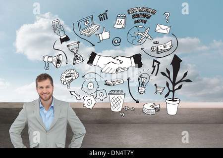 Composite image of stylish man smiling with hands on hips Stock Photo