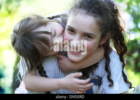 Happy family moments - sisters have a fun. Stock Photo