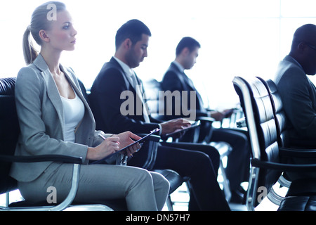 Row of business people making notes at seminar Stock Photo
