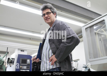 A technical worker engineer is working in factory or workshop Stock Photo