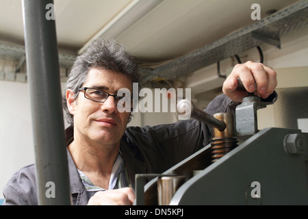 A technical worker engineer is working in factory or workshop Stock Photo