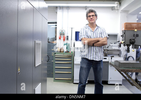 A technical worker engineer is working in factory or workshop Stock Photo