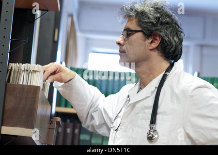 a doctor middle old man caucasian person is standing in a library Stock Photo