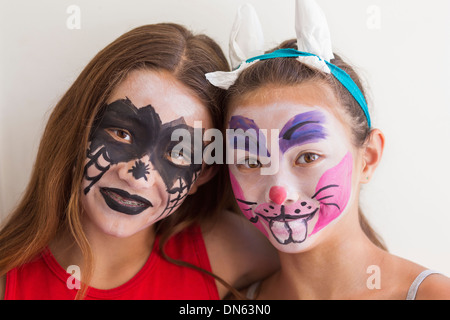 Mixed race girls wearing face paint Stock Photo