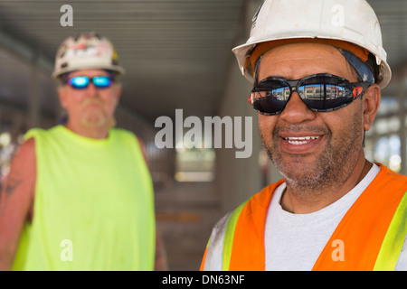 Workers smiling at construction site Stock Photo