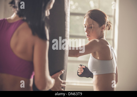 Woman working with trainer in gym Stock Photo