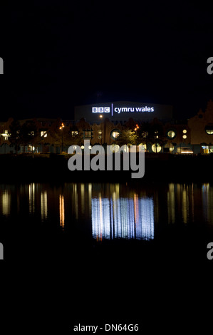 The illuminated BBC Roath Lock studios besides Roath Basin Cardiff Bay Cardiff, Wales. Stock Photo