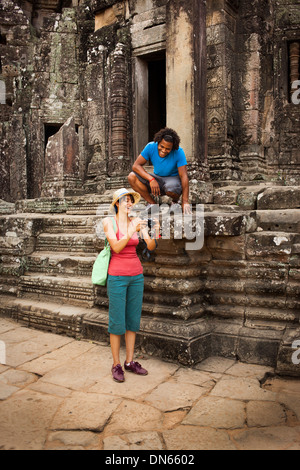 Couple visiting ancient temple, Angkor, Siem Reap, Cambodia Stock Photo