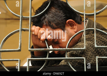 Dhaka, Bangladesh. 19th Dec, 2013. A man falls asleep at the Komlapur railway station during the 72-hour country wide road-rail-waterway blockade in Dhaka, capital of Bangladesh, on Dec. 19, 2013. Bangladesh Nationalist Party (BNP) and its allies called for blockade of road, rail and water transport as protesters reject the upcoming 10th parliament elections schedule and demand holding the election under a non party government. Credit:  Shariful Islam/Xinhua/Alamy Live News Stock Photo