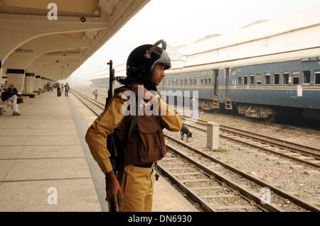 Dhaka, Bangladesh. 19th Dec, 2013. A security member stands guard at the Komlapur railway station during the 72-hour country wide road-rail-waterway blockade in Dhaka, capital of Bangladesh, on Dec. 19, 2013. Bangladesh Nationalist Party (BNP) and its allies called for blockade of road, rail and water transport as protesters reject the upcoming 10th parliament elections schedule and demand holding the election under a non party government. Credit:  Shariful Islam/Xinhua/Alamy Live News Stock Photo