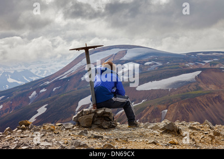 Walker Resting on the Summit of Blahnukur Near Landmannalaugar Iceland Stock Photo