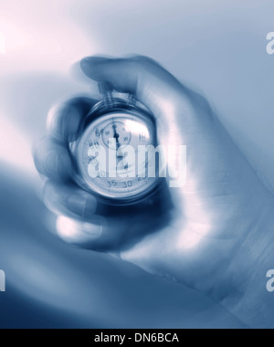 Stopwatch in hand Stock Photo