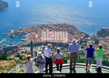 Dubrovnik - tourists looking down to the fortified walls of the city from the summit of Mount Srd,next to  the Dubrovnik cable car, Croatia Stock Photo