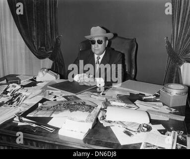Nov. 3, 1971 - JEAN-PIERRE MELVILLE wearing a cowboy hat and sunglasses sitting at his desk. Stock Photo