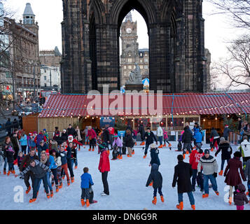 19 Dec. 2013, Edinburgh Christmas Ice Rink, Princes Street Gardens, Scotland, UK. Families and teenagers appear to be enjoying skating on a bright afternoon a week before Christmas Stock Photo